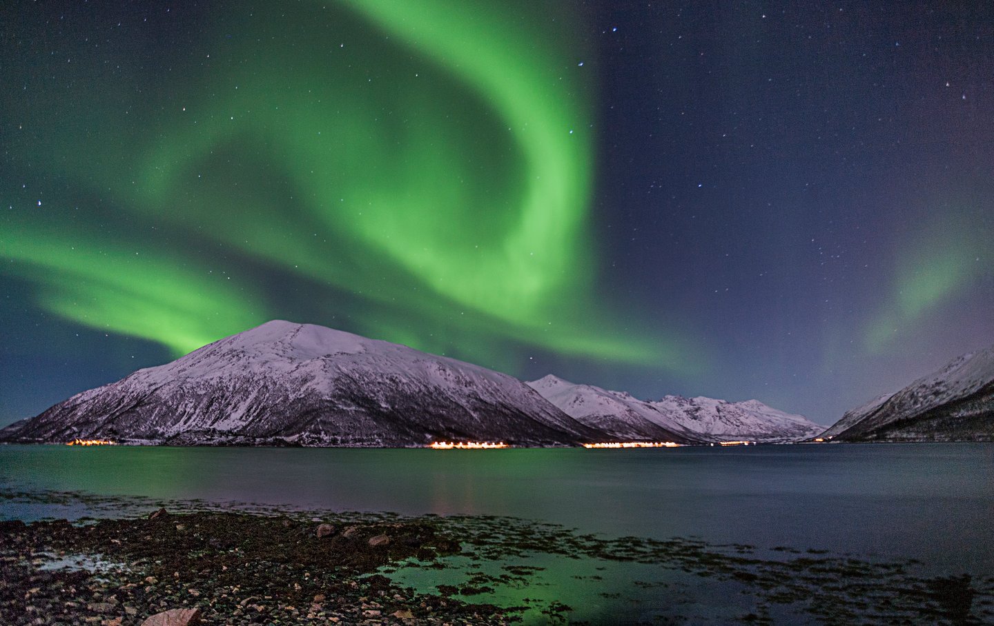 Northern lights dance over Lake Tornetrask in winter