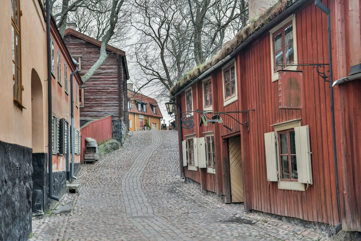 Street lined with with historic timber houses at Skansen open-air museum in Stockholm, 