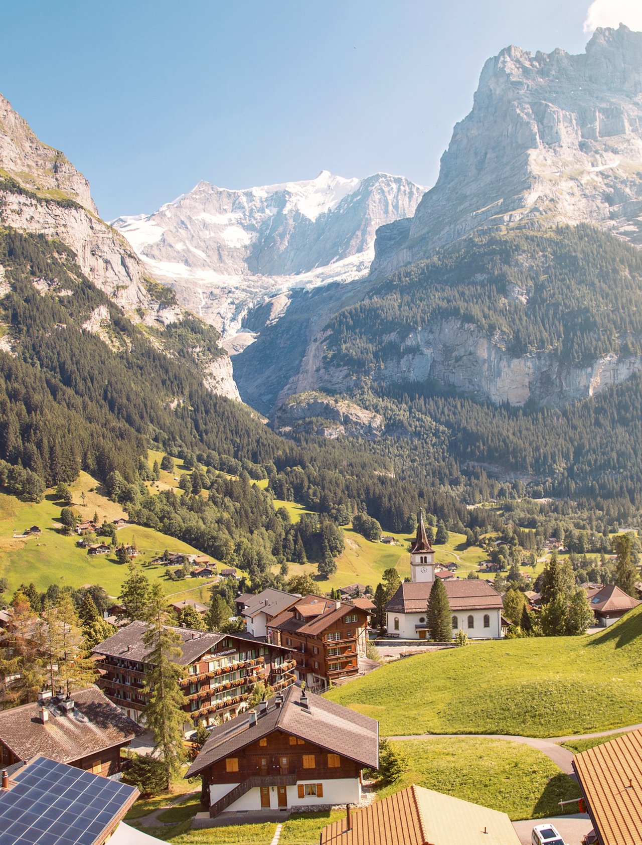 Eiger, Monch and Jungfrau mountains above Grindelwald village