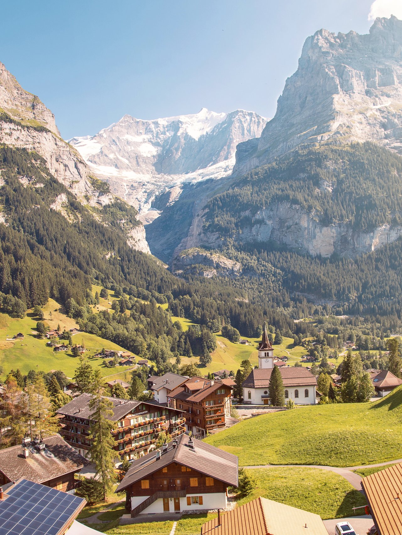 Eiger, Monch and Jungfrau mountains above Grindelwald village