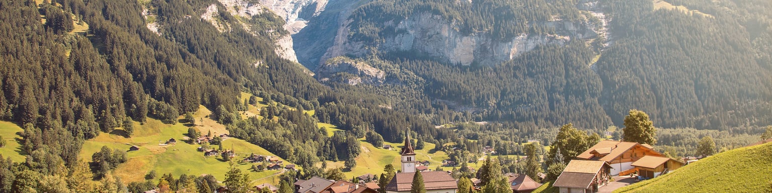 Eiger, Monch and Jungfrau mountains above Grindelwald village