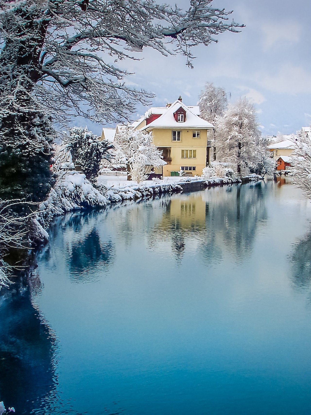 Snow covered houses along the river in Interlaken, Switzerland