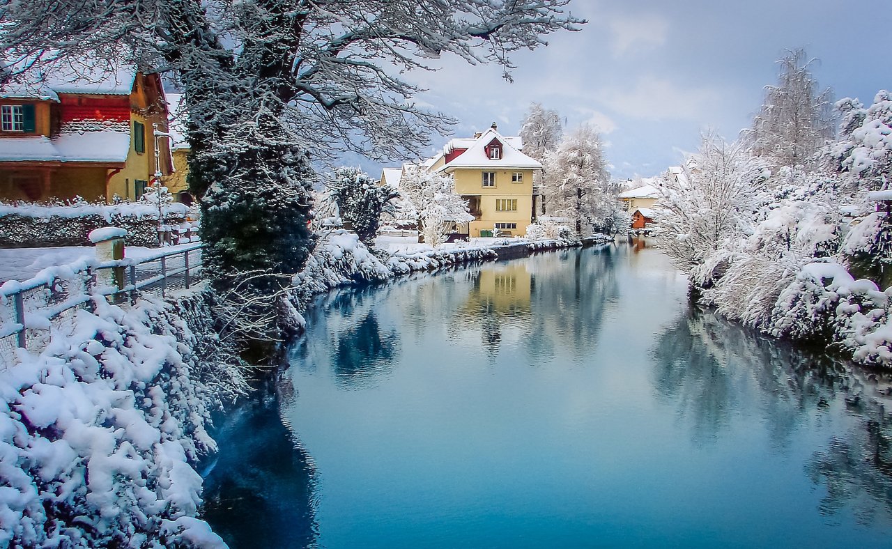 Snow covered houses along the river in Interlaken, Switzerland
