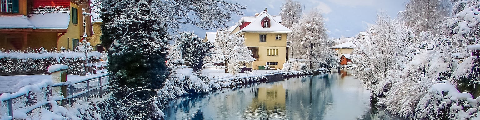 Snow covered houses along the river in Interlaken, Switzerland