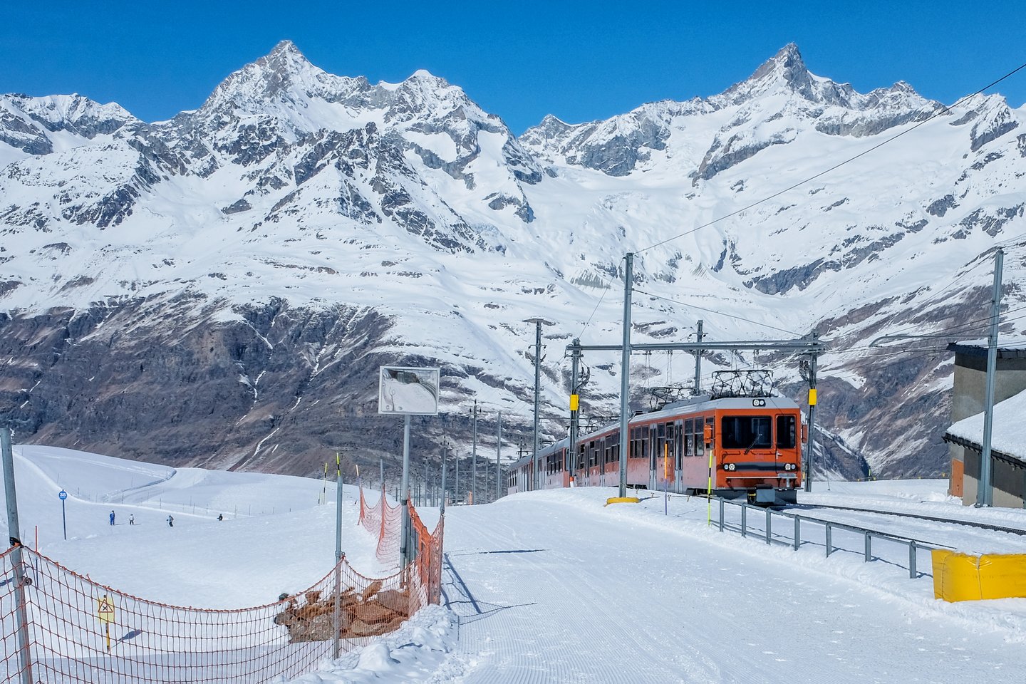 A red train en route to Interlaken, Switzerland.