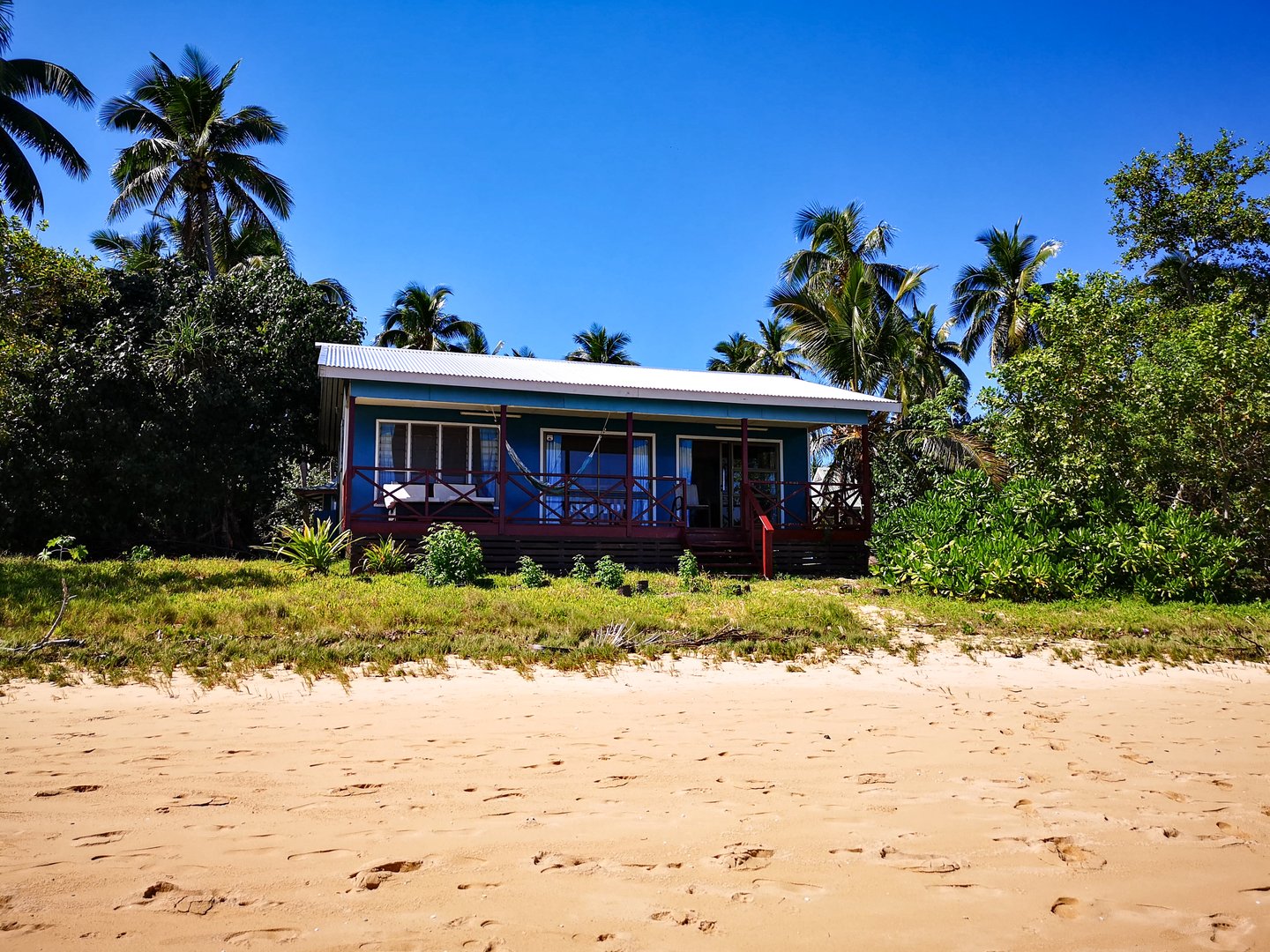 Blue cottage on the beach in Tonga