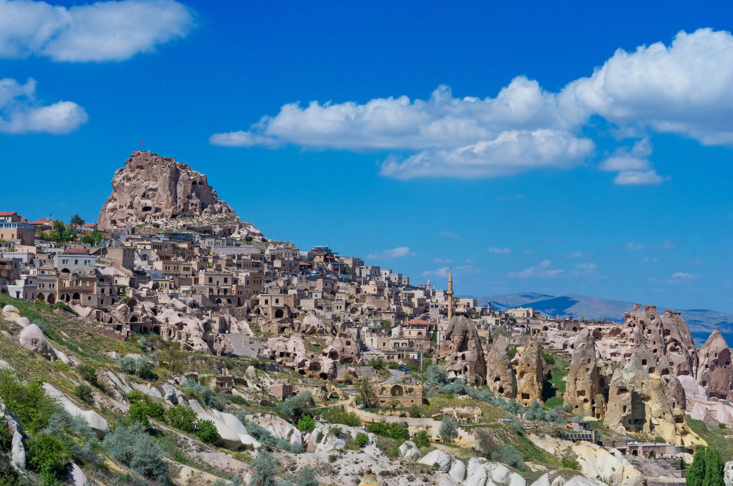 Uçhisar Castle towering over the town in Cappadocia, Turkey