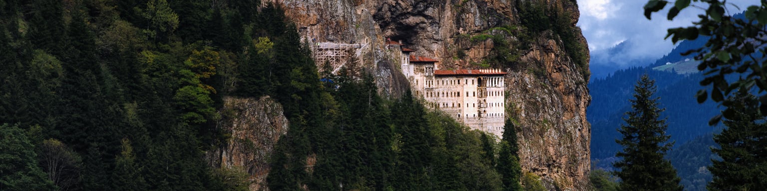 Sumela Monastery tucked into the mountains and surrounded by forest
