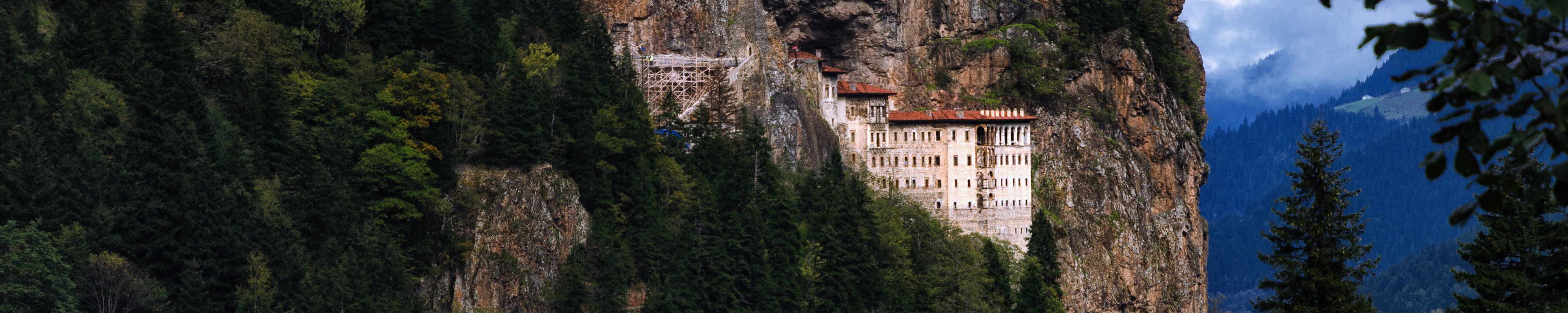 Sumela Monastery tucked into the mountains and surrounded by forest