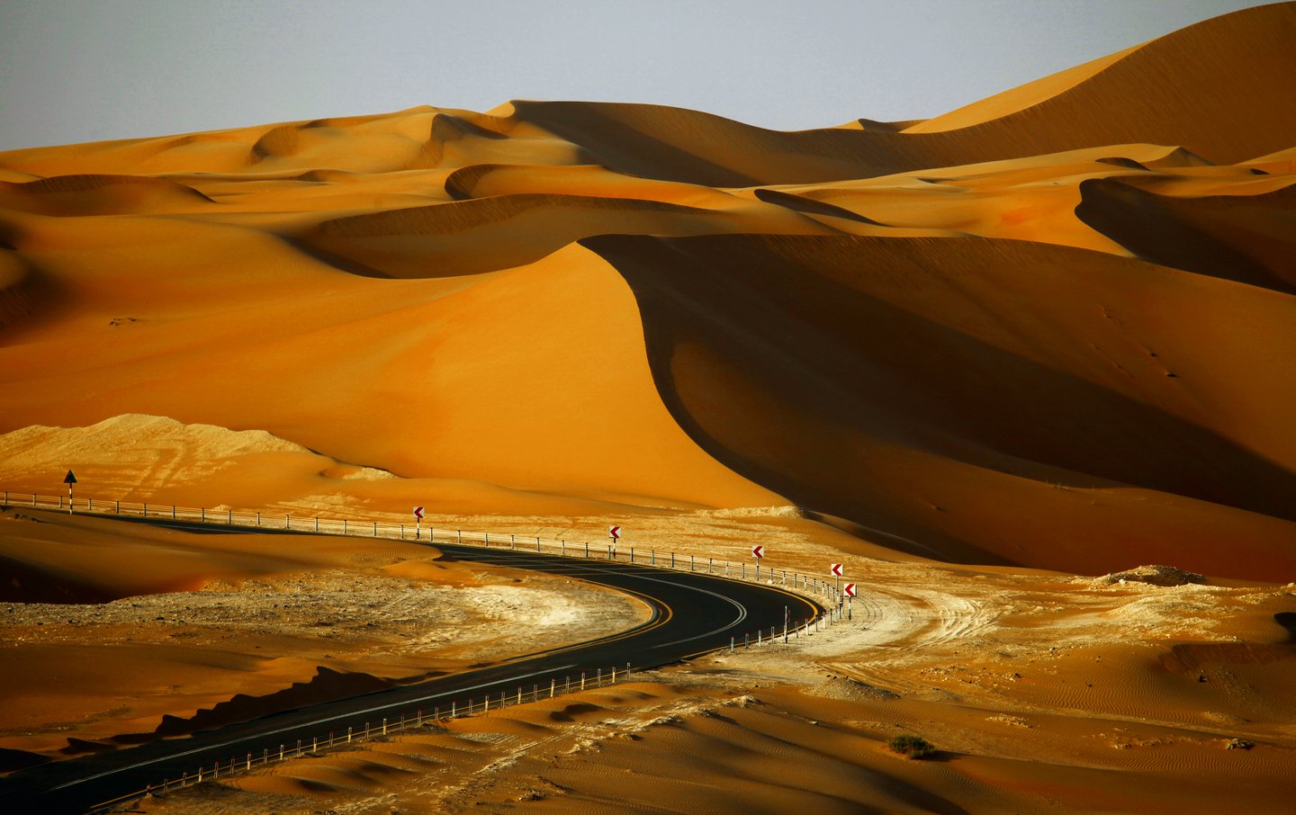 A road surrounded by dunes at the Liwa Oasis, Abu Dhabi
