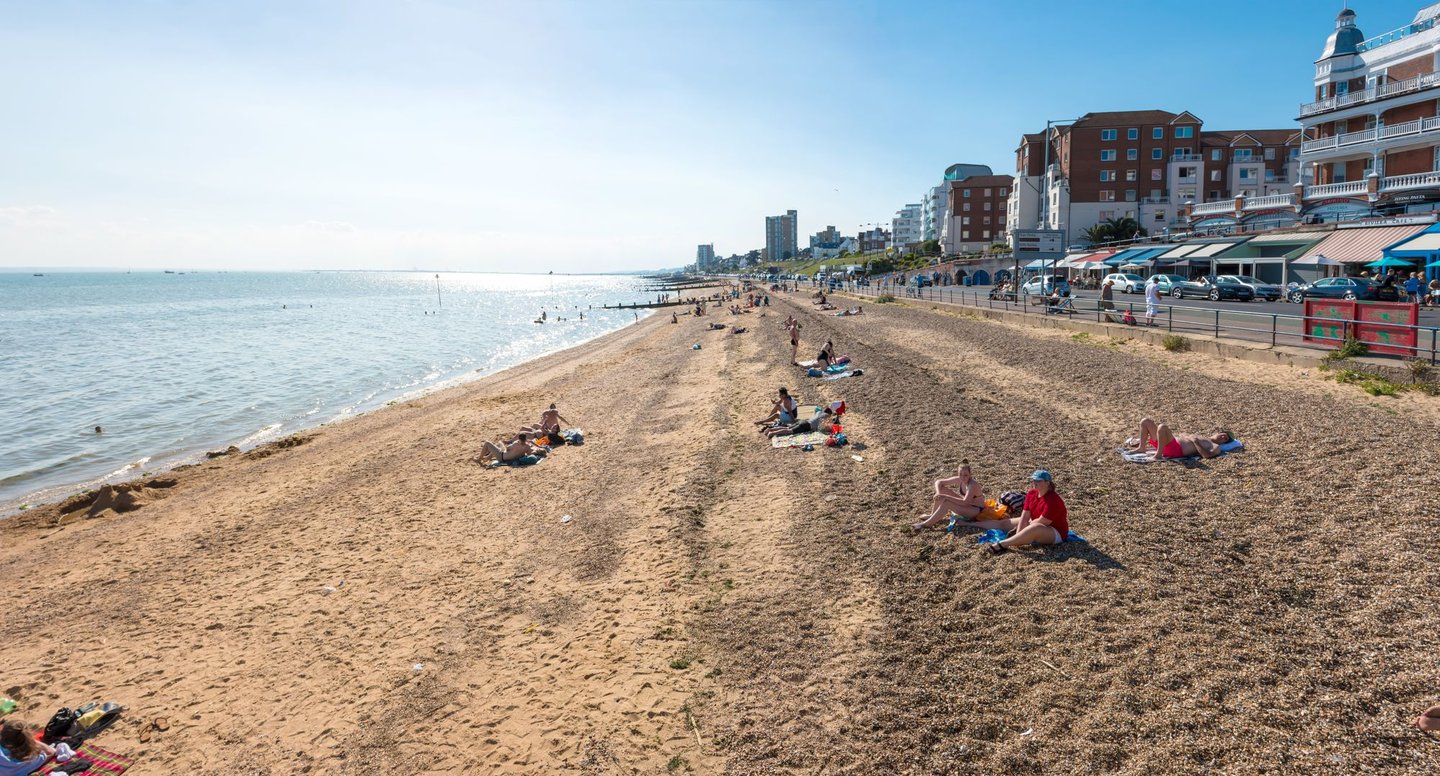People sitting at the beach on a sunny day at Southend-on-Sea 
