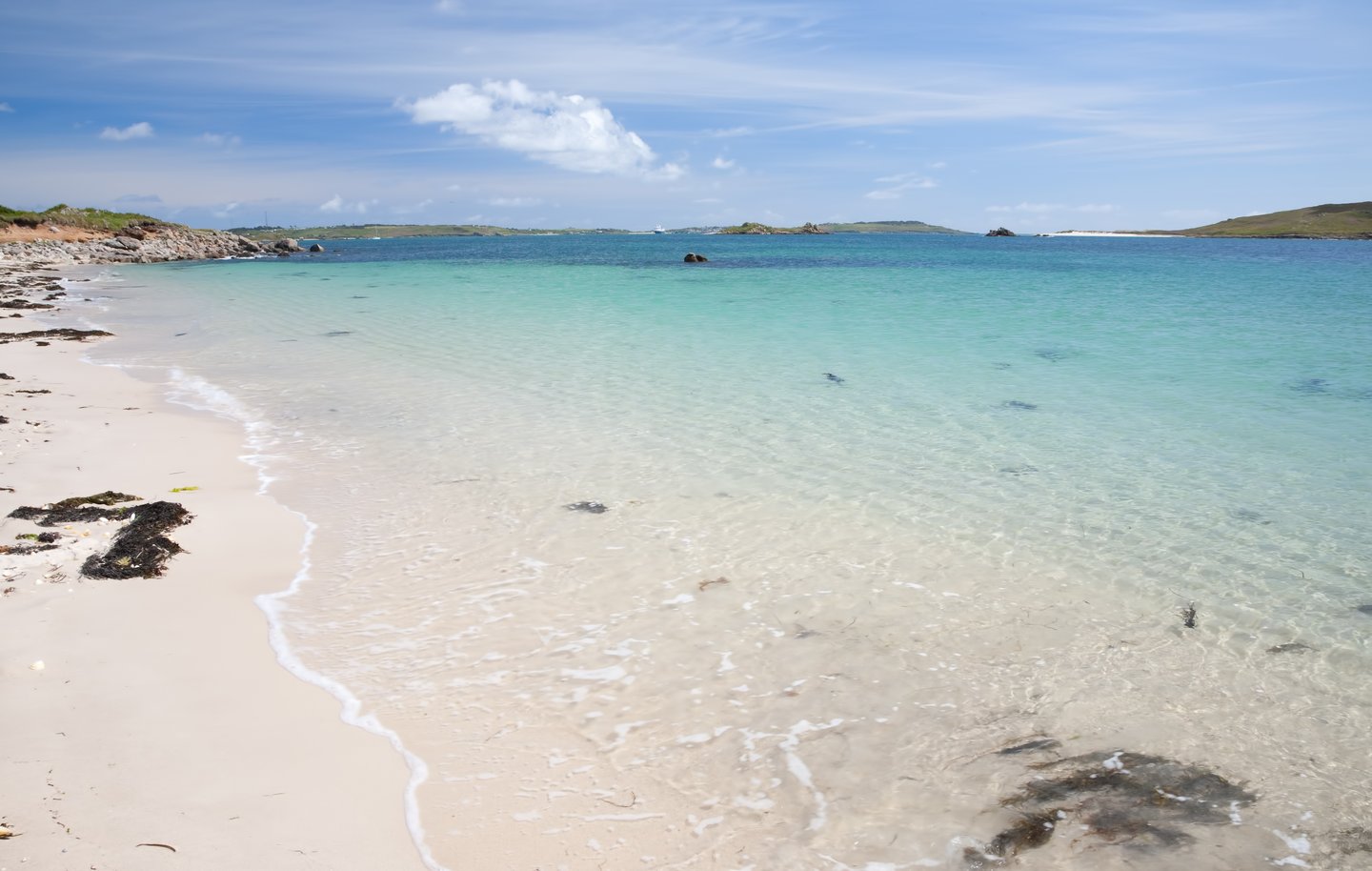 A white sandy beach with clear waters on Bryher Island in the Isles of Scilly