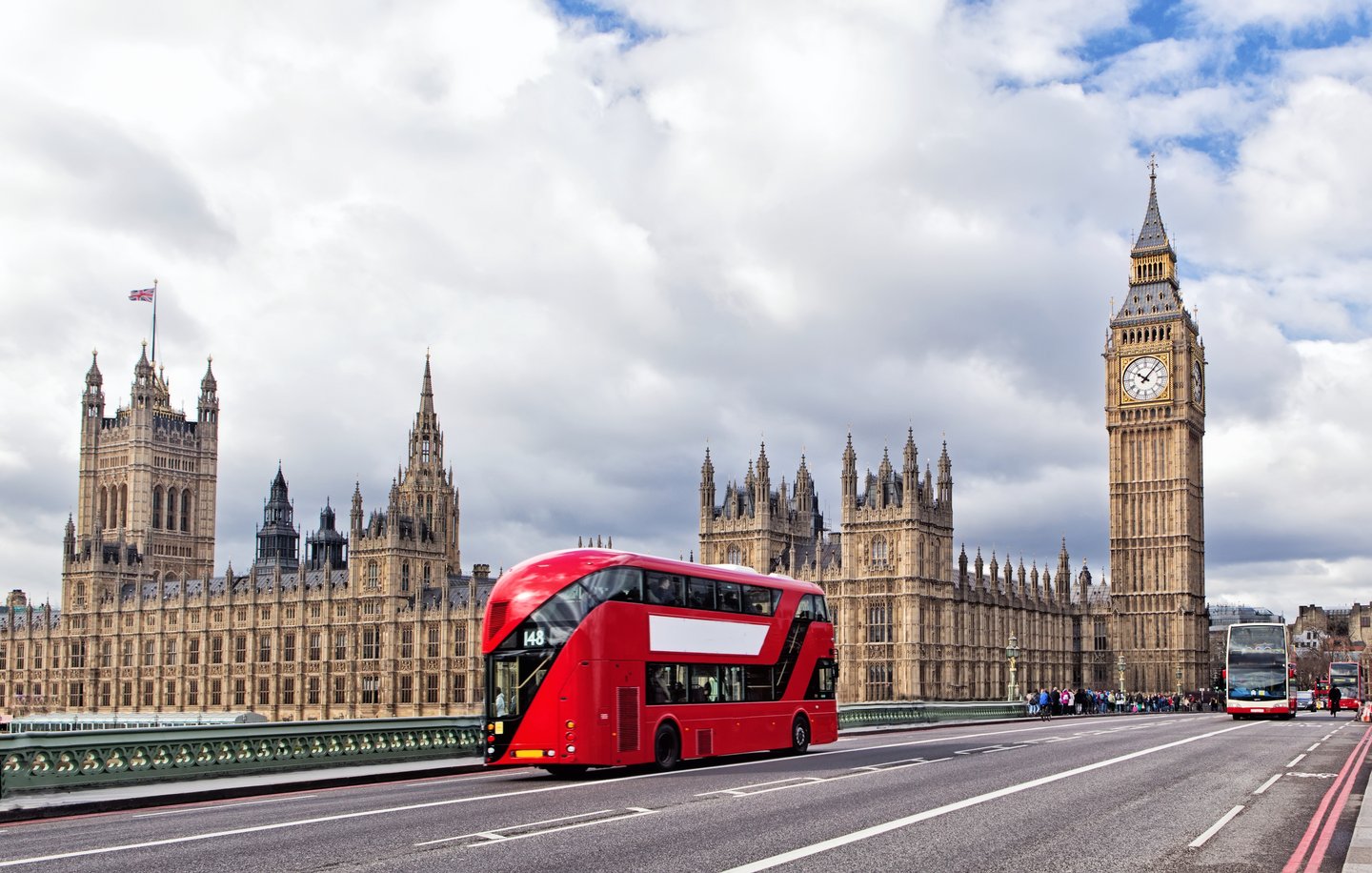 A London bus on Westminster Bridge with the Houses of Parliament and Big Ben in the background. 