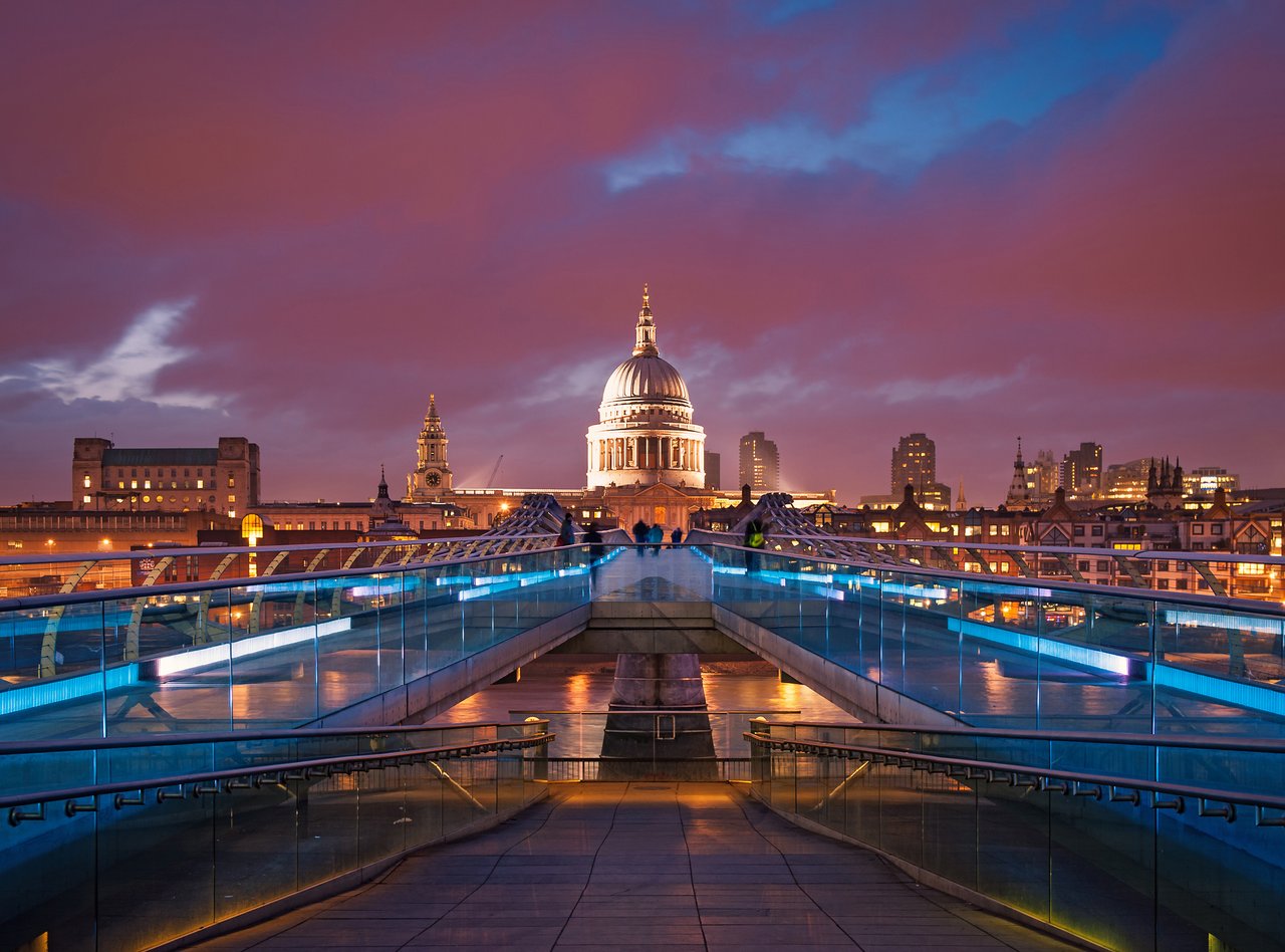 People walking over Millennium Bridge in London