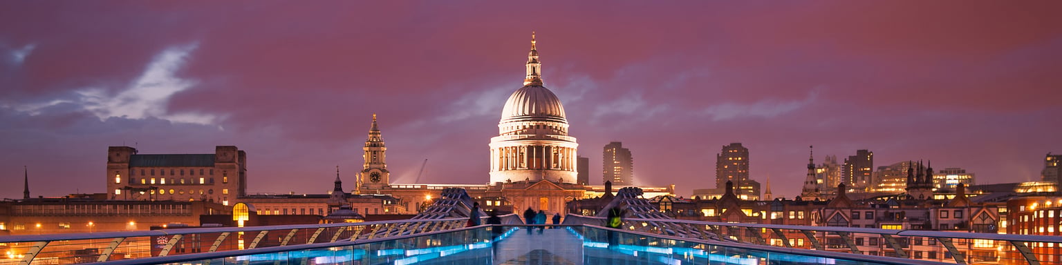 People walking over Millennium Bridge in London