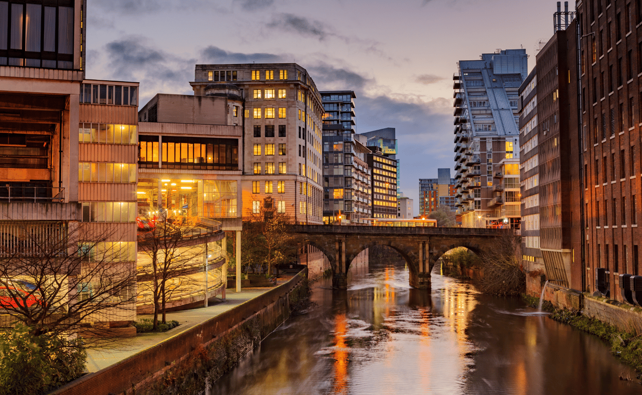 Modern apartments on both side of river Irwell passing through Manchester city center, UK.