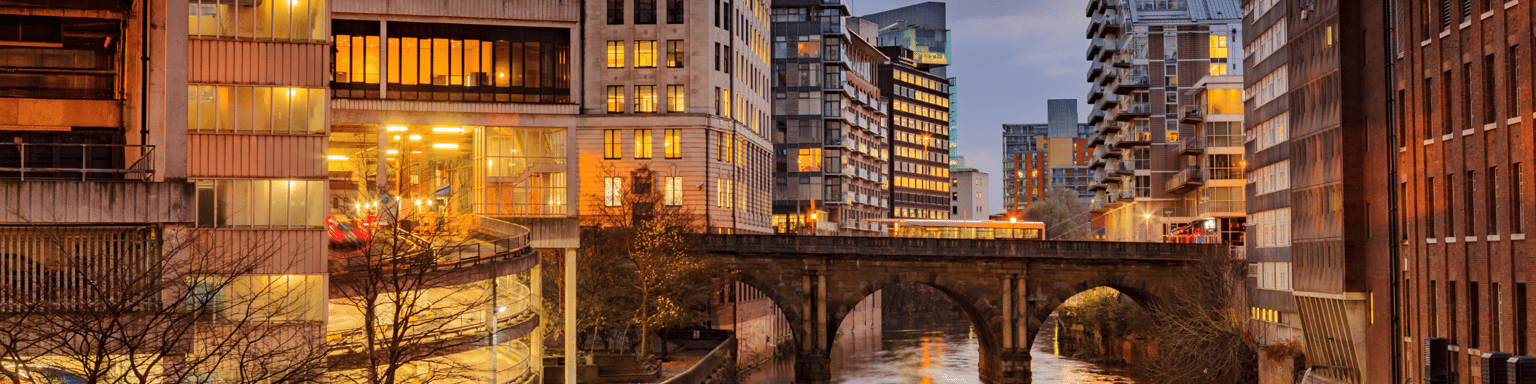 Modern apartments on both side of river Irwell passing through Manchester city center, UK.