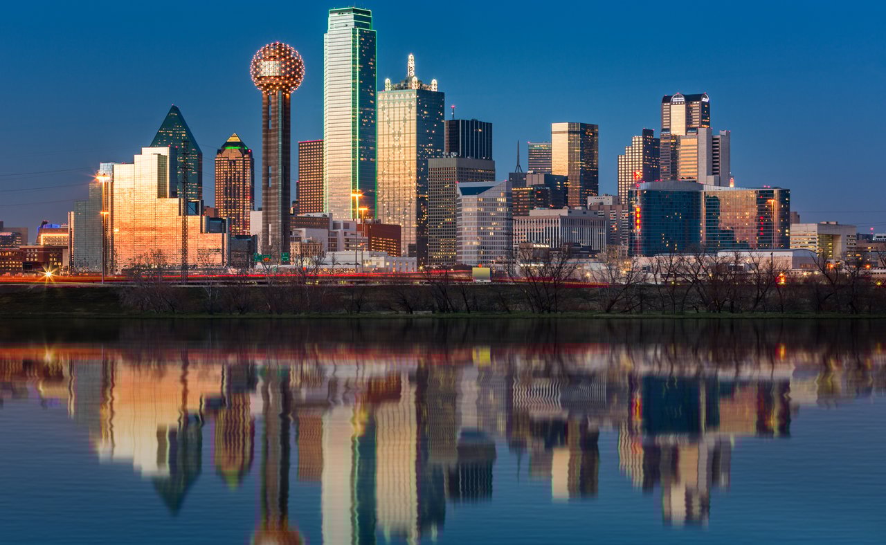The skyline of Dallas reflected in the water at night