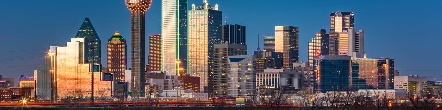 The skyline of Dallas reflected in the water at night