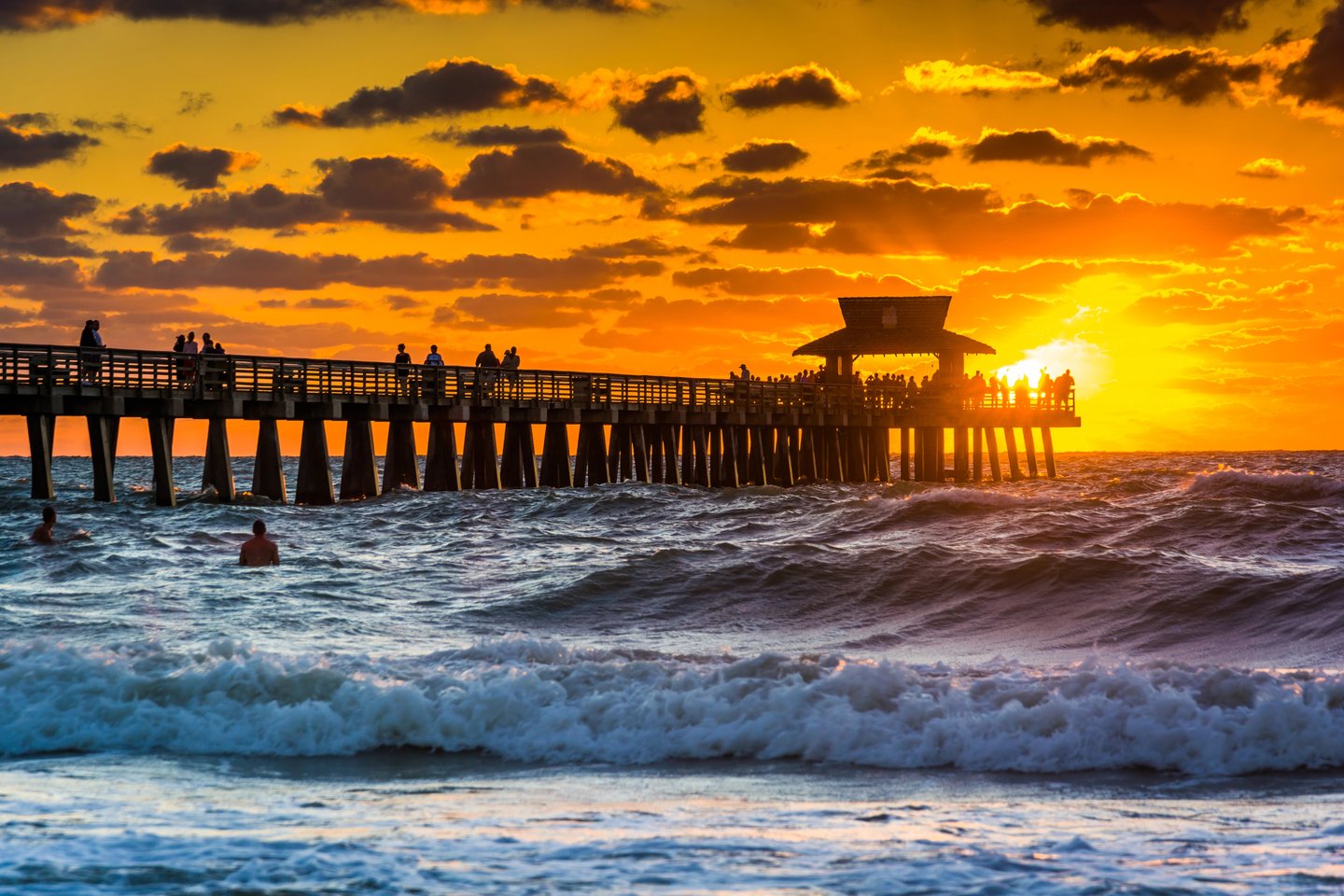 The sun setting behind the pier in Naples, Florida.
