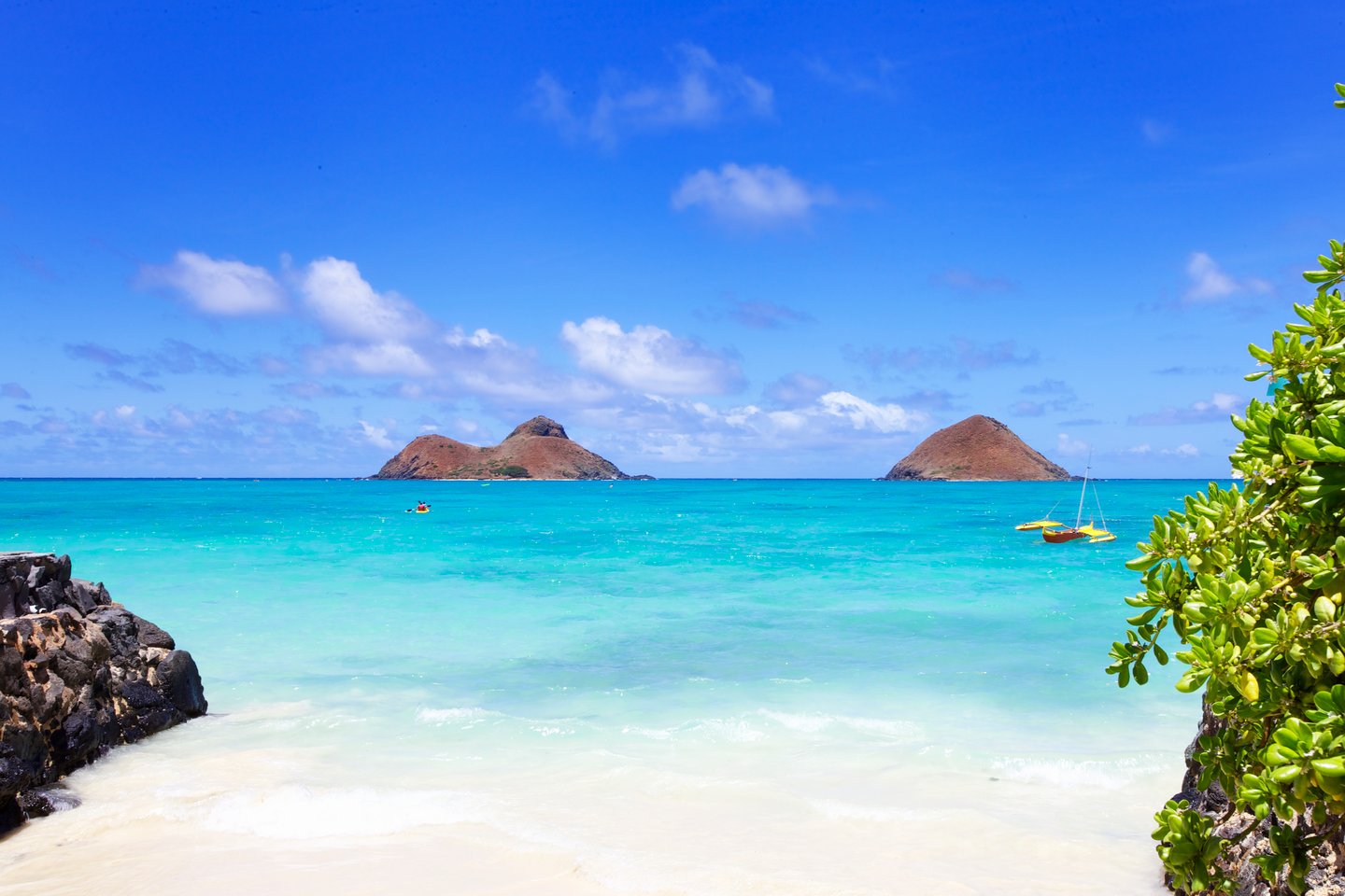 The blue waters of Lanikai Beach with the Mokulua Islands visible in the distance