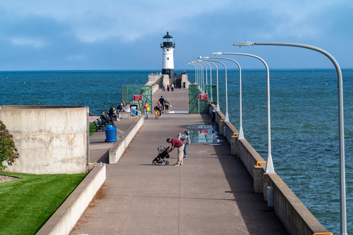People enjoy a beautiful autumn day by the Canal Park lighthouse on Lake Superior