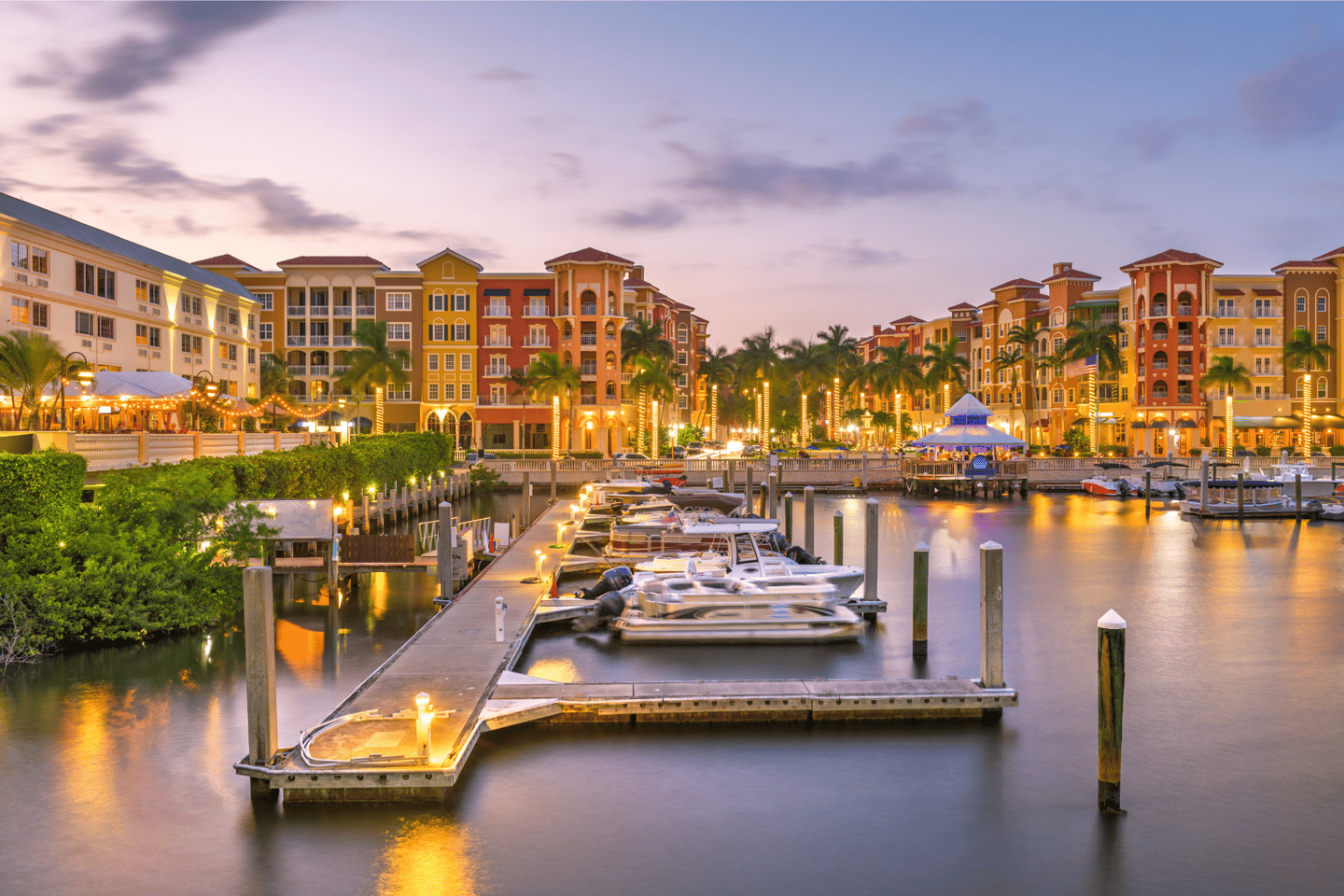 Naples, Florida, USA town skyline on the water at dusk.