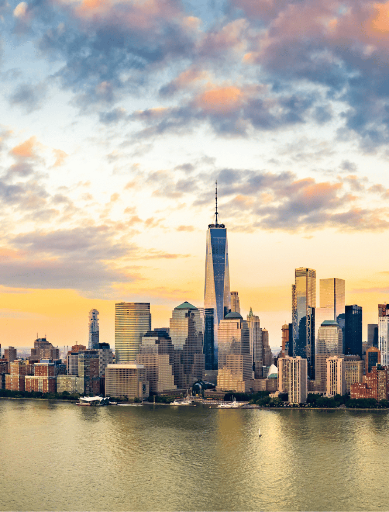 Aerial panorama of New York City skyline at sunset with both midtown and downtown Manhattan