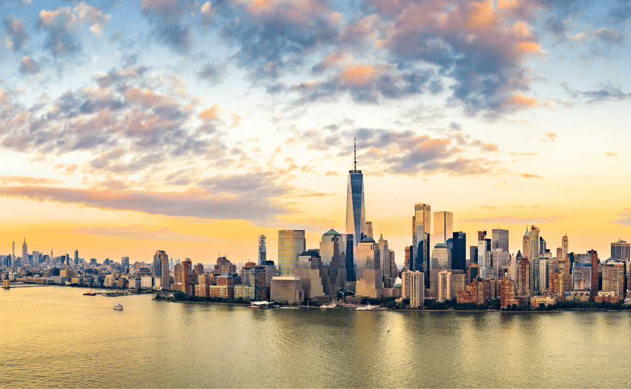 Aerial panorama of New York City skyline at sunset with both midtown and downtown Manhattan