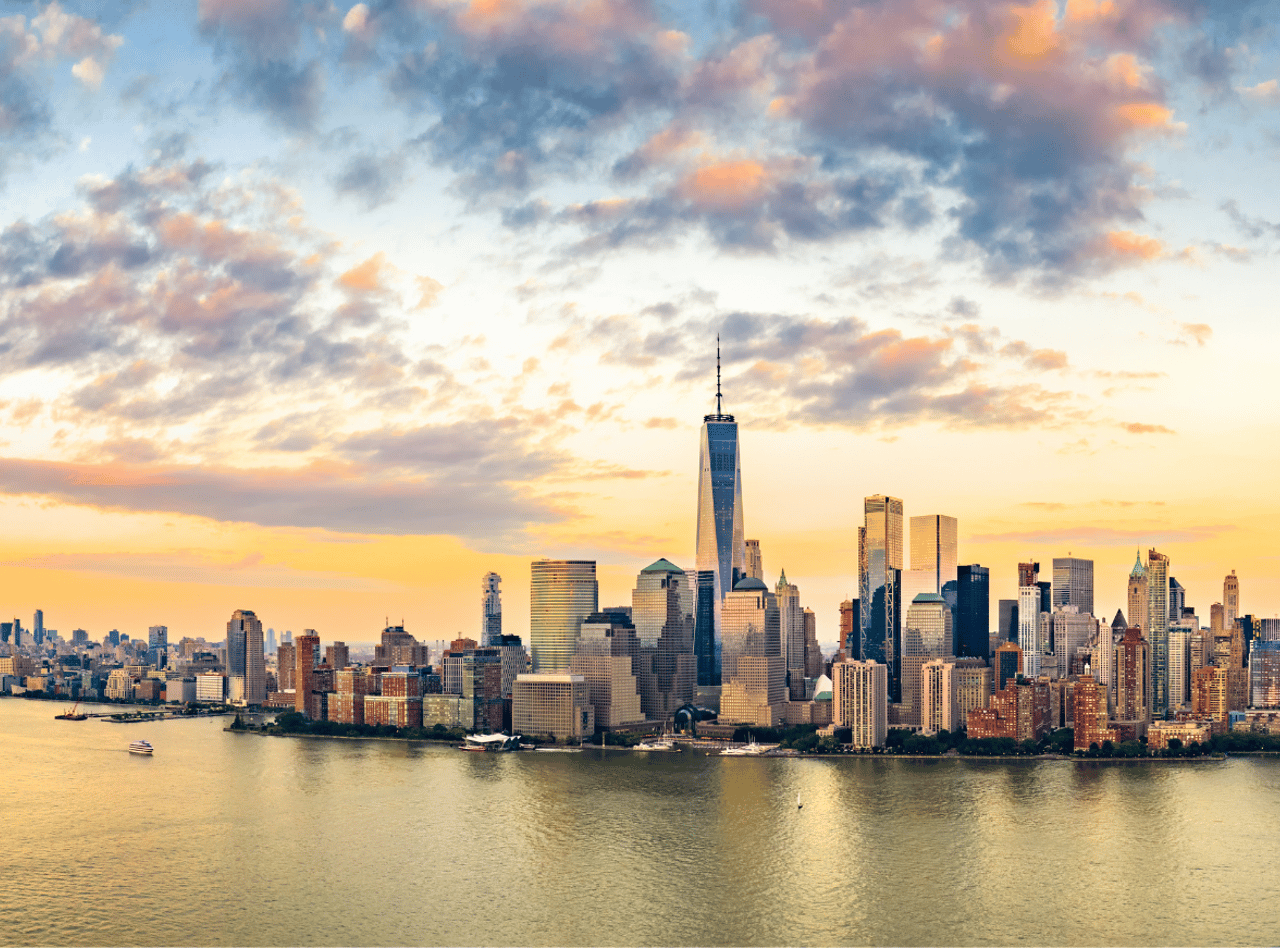 Aerial panorama of New York City skyline at sunset with both midtown and downtown Manhattan
