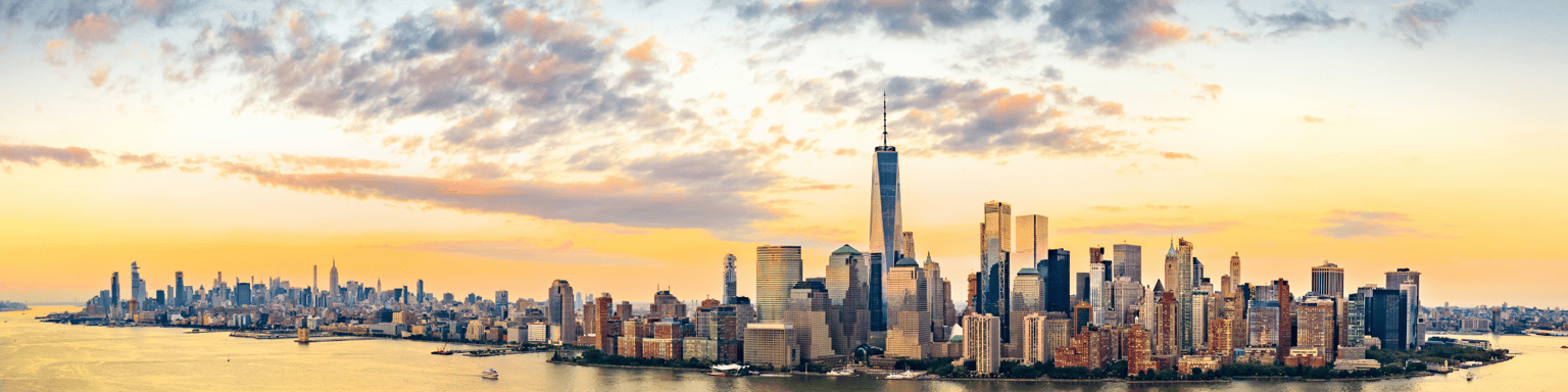 Aerial panorama of New York City skyline at sunset with both midtown and downtown Manhattan