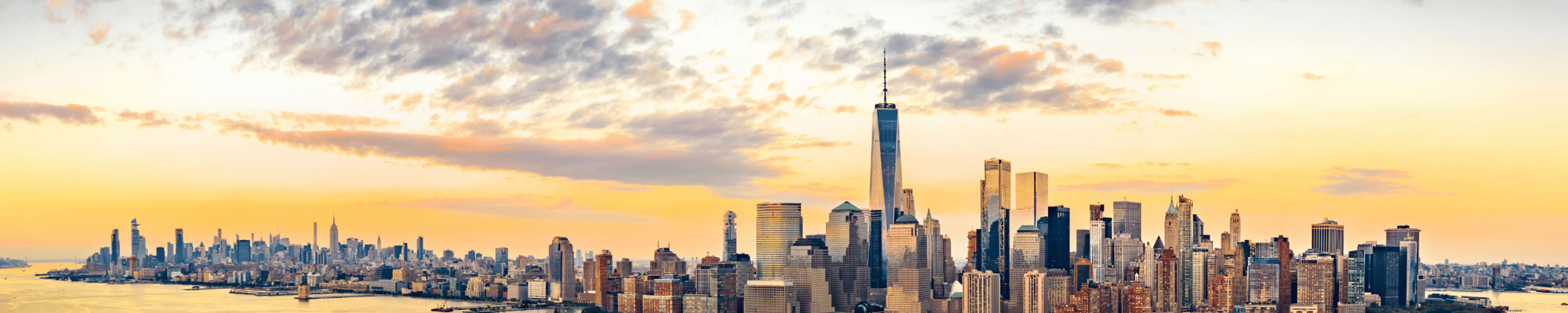 Aerial panorama of New York City skyline at sunset with both midtown and downtown Manhattan