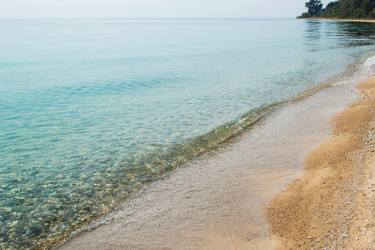 Clear waters lapping on the beach at Lake Tanganyika, Zambia
