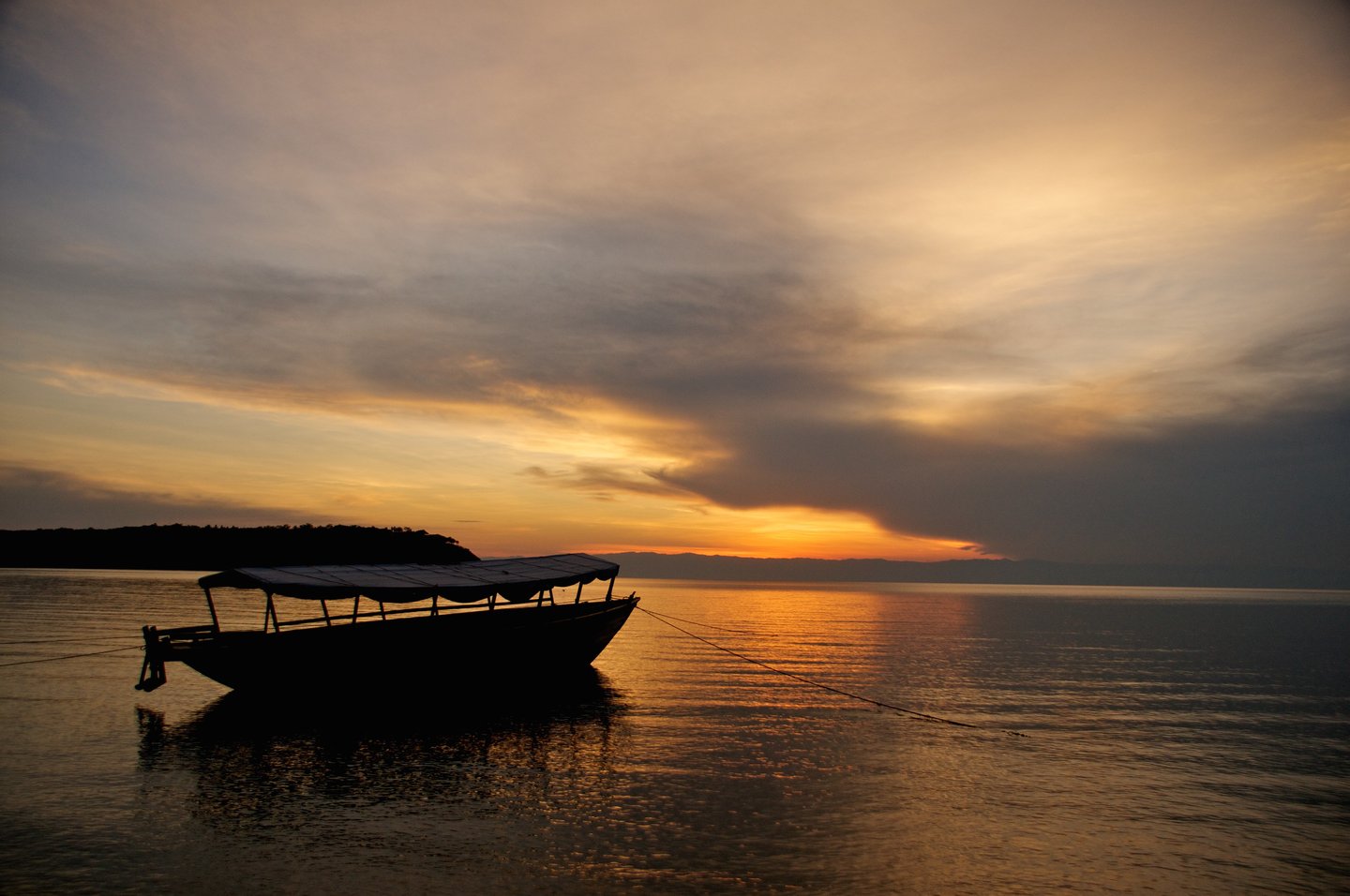 A boat silhouetted against the sunset at Lake Tanganyika