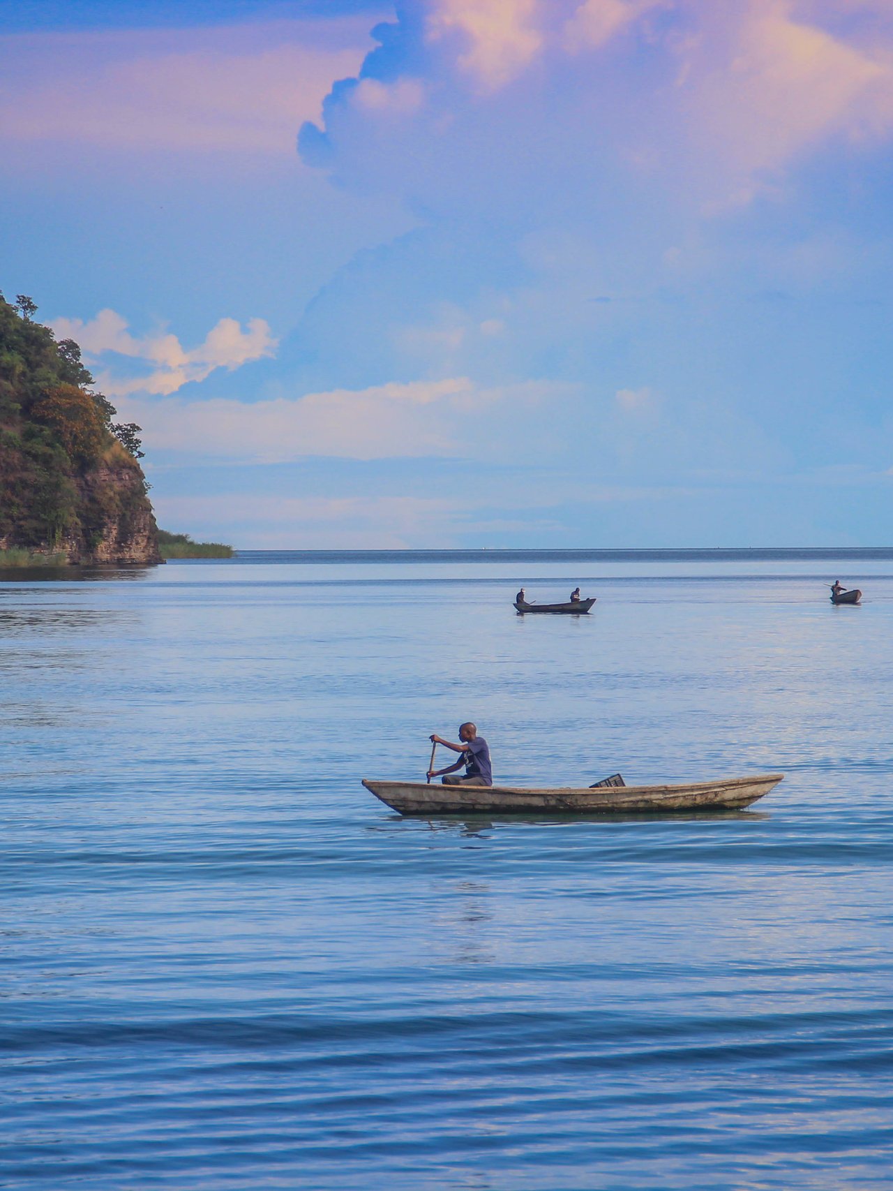 A fishing boat sails on Lake Tanganyika on a sunny day