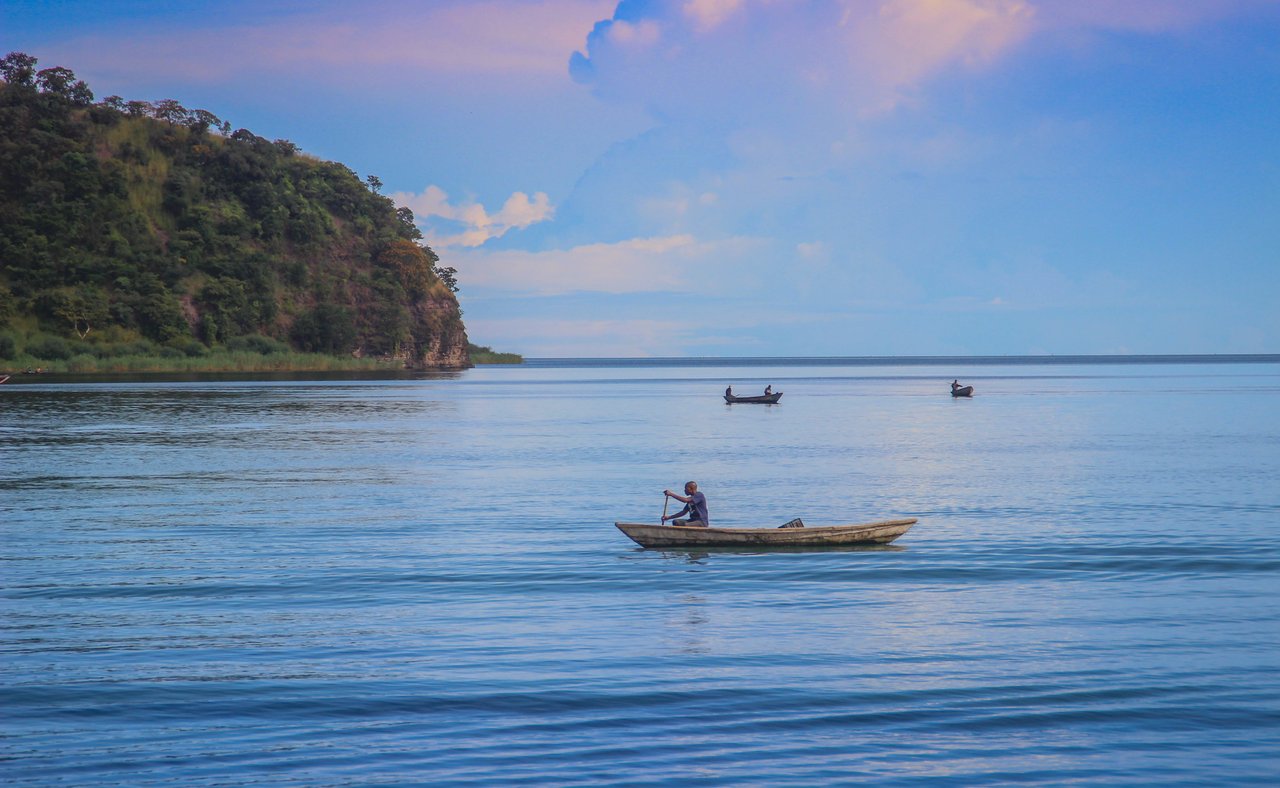 A fishing boat sails on Lake Tanganyika on a sunny day