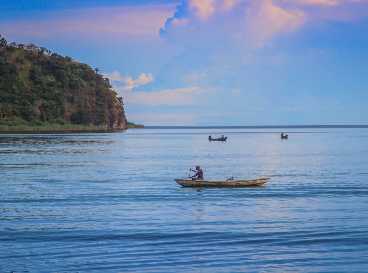 A fishing boat sails on Lake Tanganyika on a sunny day