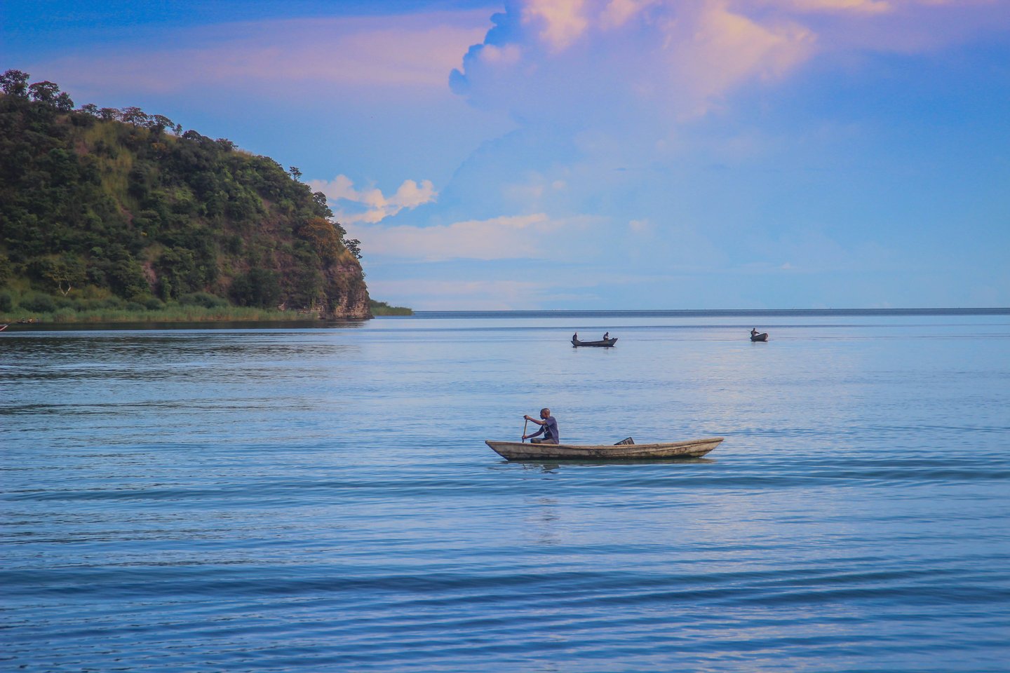 A fishing boat sails on Lake Tanganyika on a sunny day