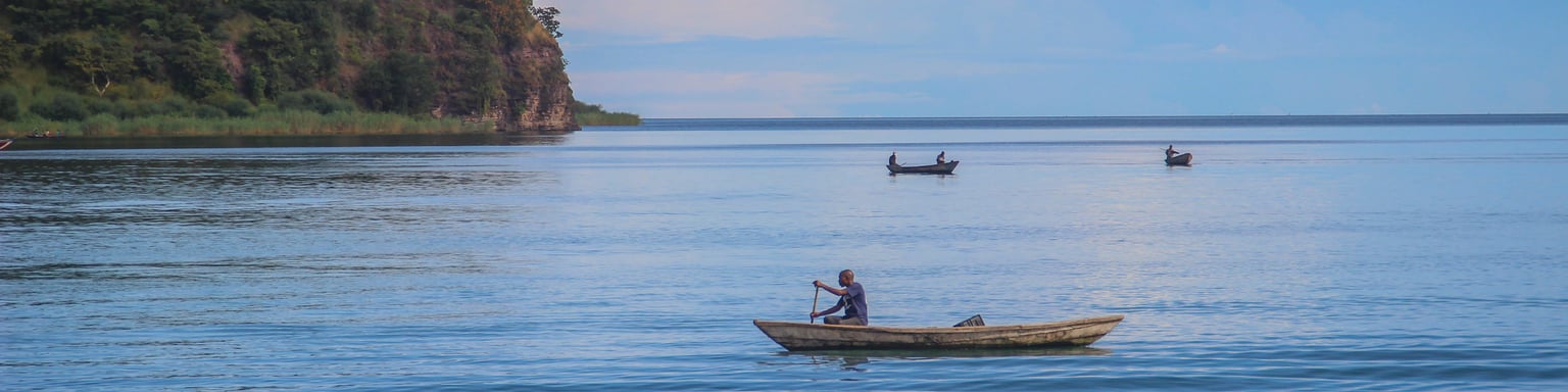 A fishing boat sails on Lake Tanganyika on a sunny day