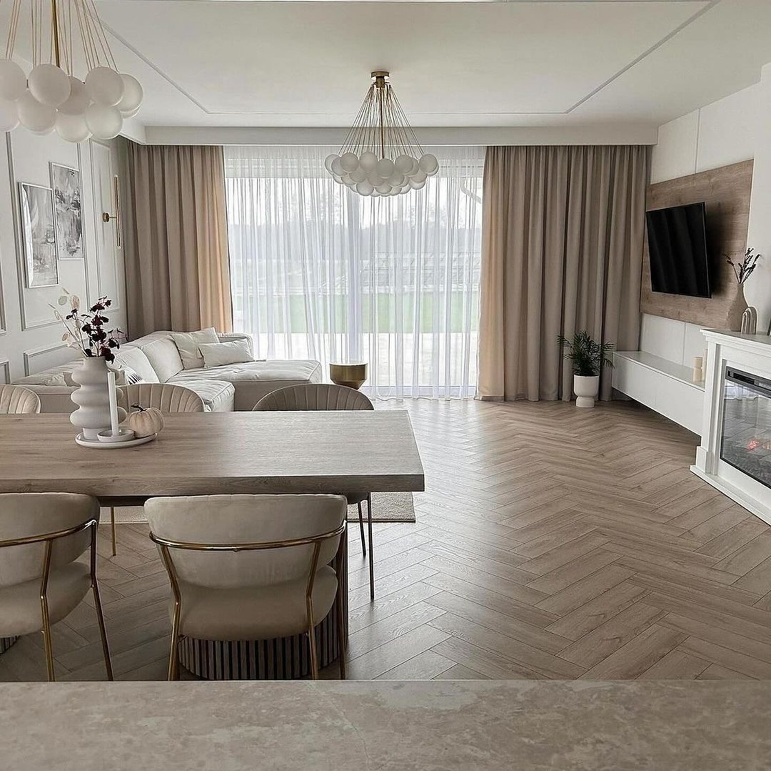 Elegant and contemporary living area with herringbone wood flooring