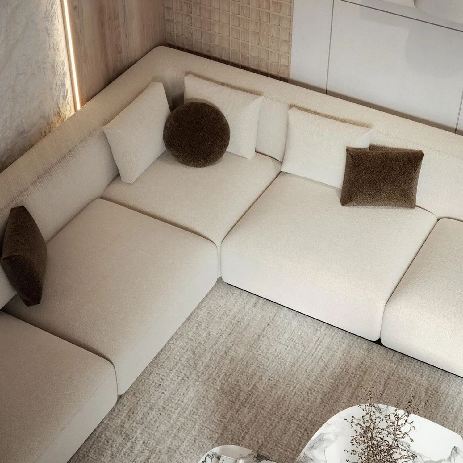 A chic, modern living room corner with plush modular sofa sections