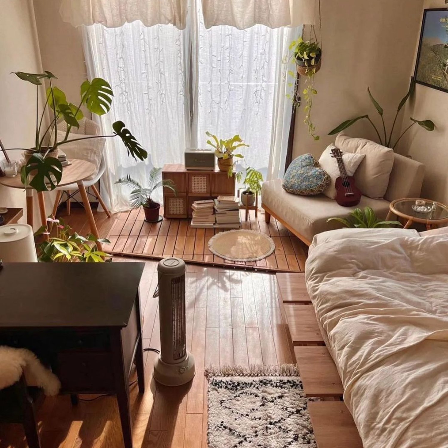 Cozy and well-lit small living space with multiple green plants and a mix of modern and rustic decor