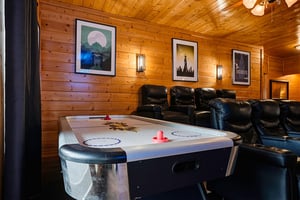 Your private game room awaits with an air hockey table and plush leather seating for friendly competition and relaxation.