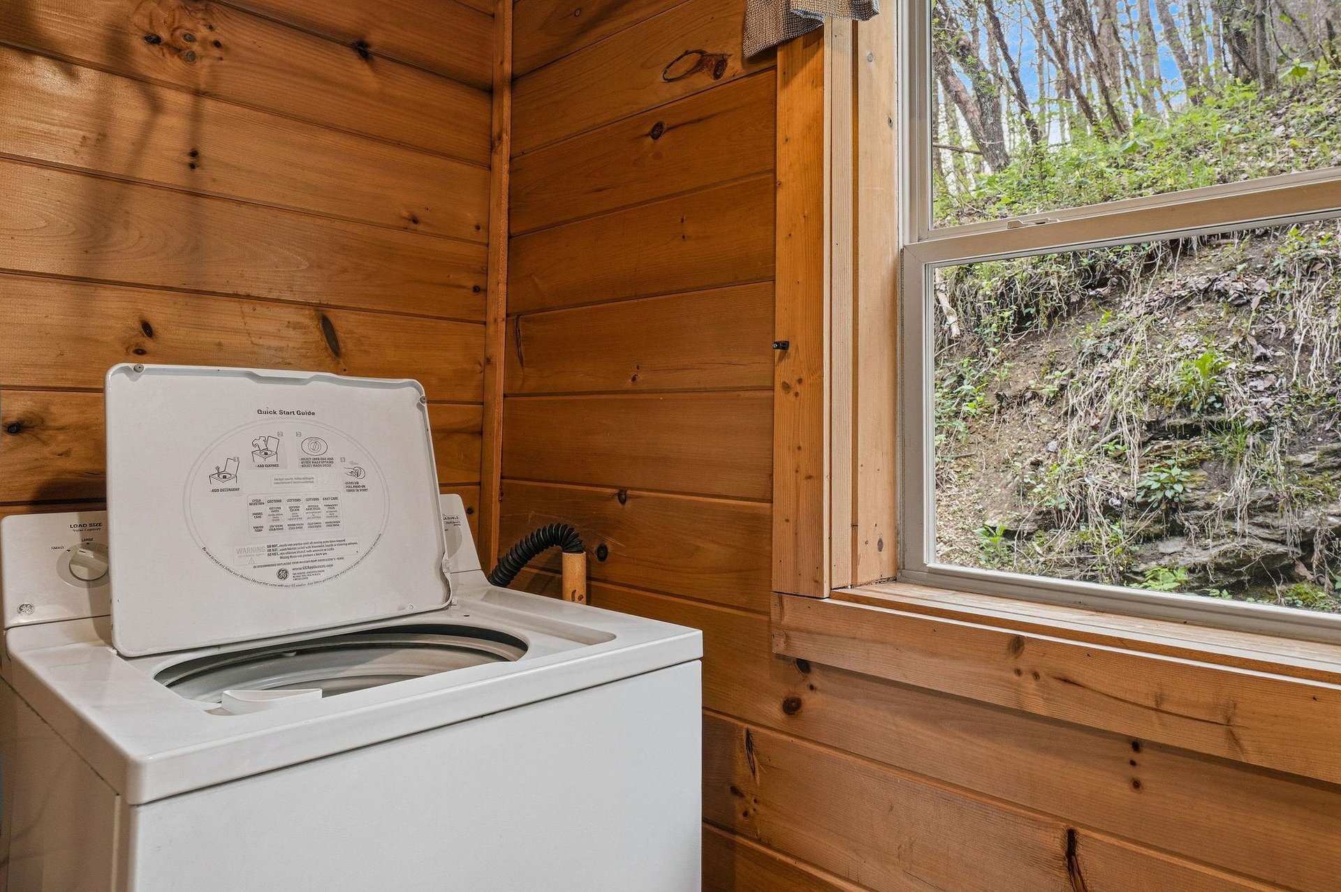 Your laundry needs are covered in this cozy woodpaneled space, where natural light streams in while you wash your vacation clothes.
