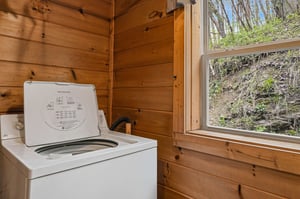 Your laundry needs are covered in this cozy woodpaneled space, where natural light streams in while you wash your vacation clothes.