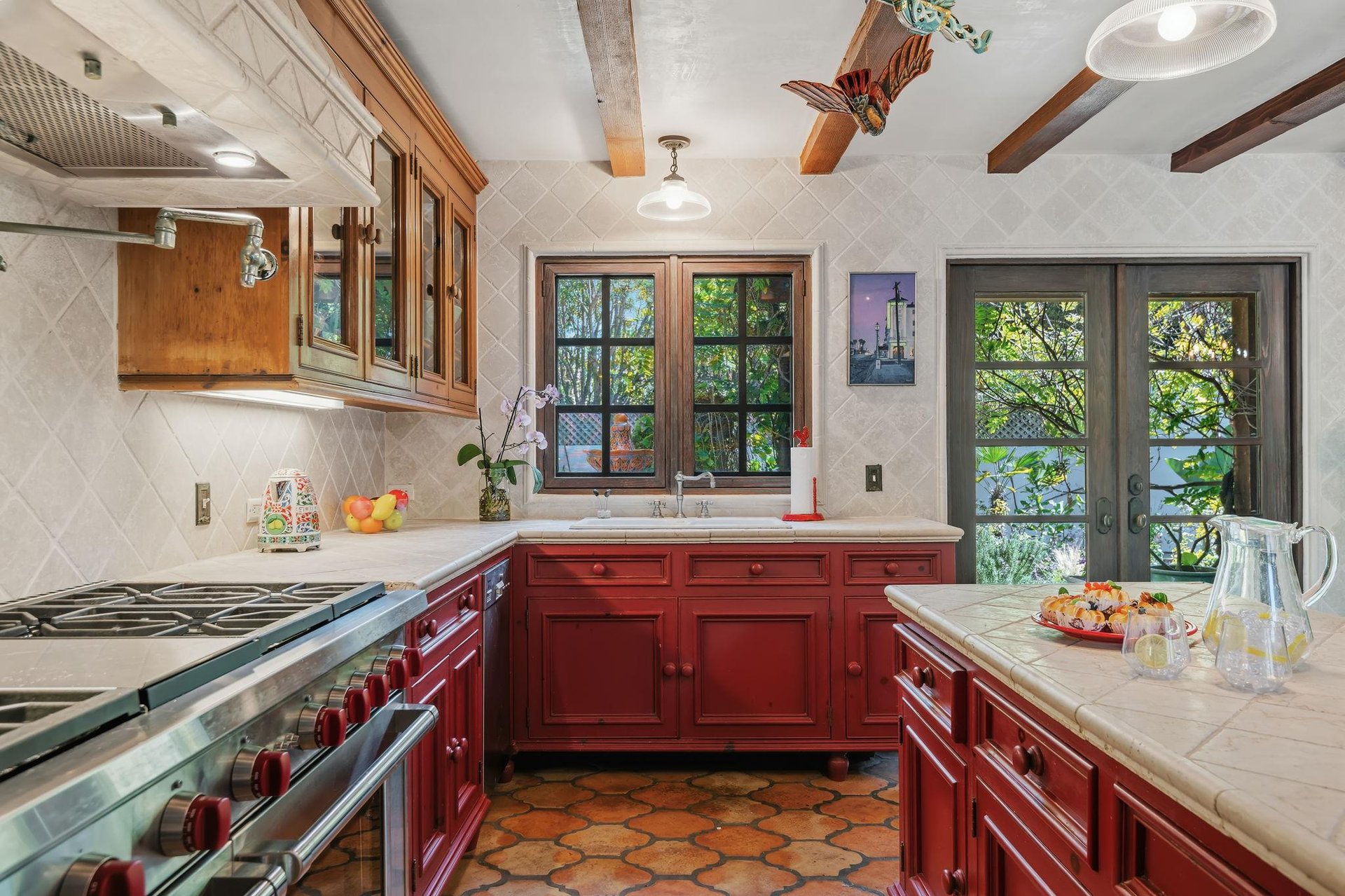 Spacious kitchen with stainless steel appliances, island with seating for 2, and cooking essentials.