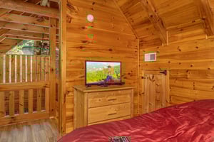 Bedroom with a dresser and TV at Walkin To Gatlinburg, a 2 bedroom cabin rental located in Gatlinburg