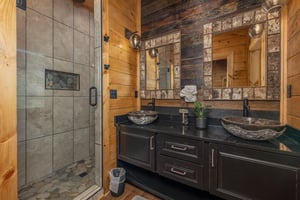 Bathroom with double sinks and large shower