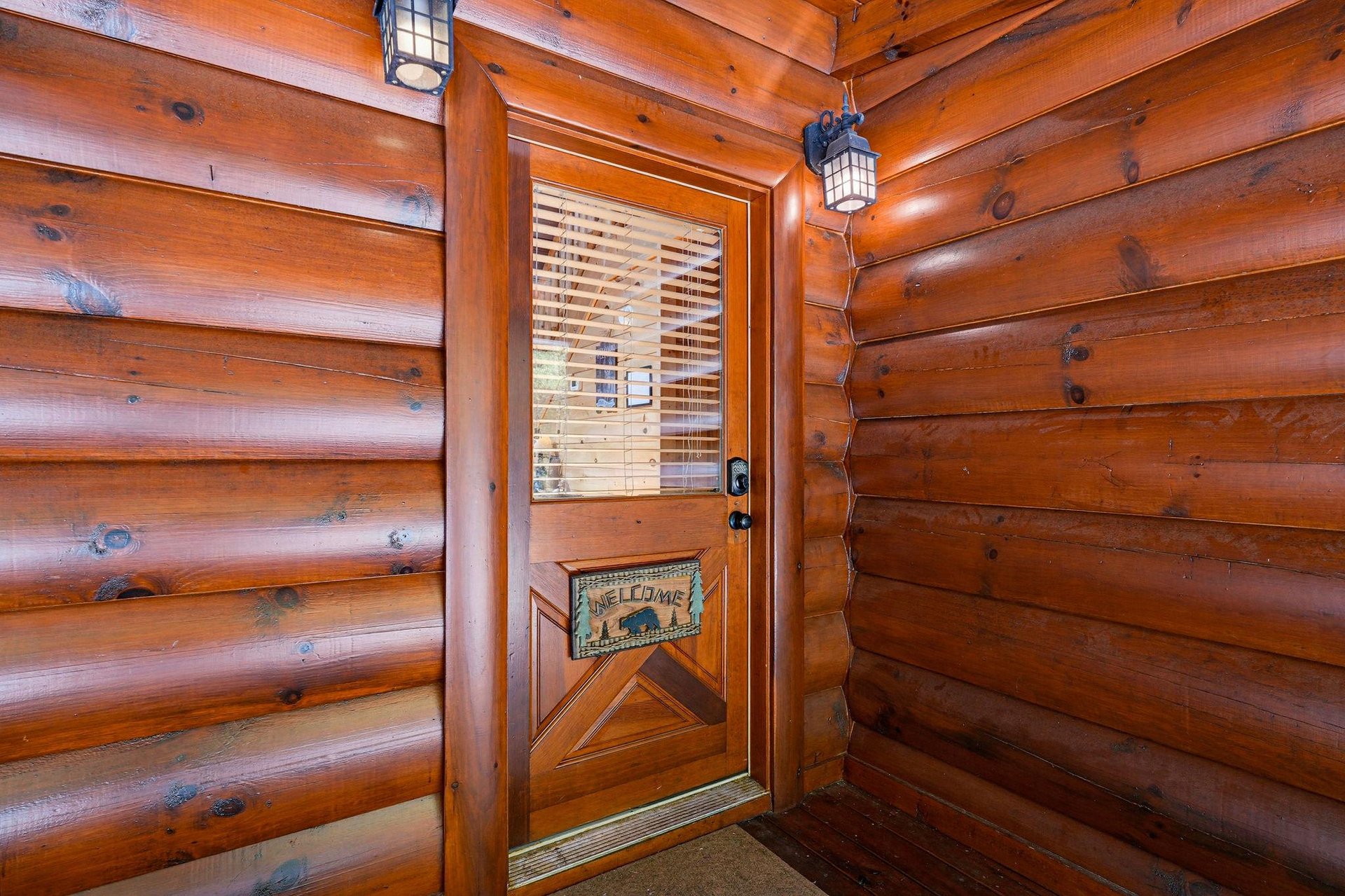 The warmth of natural wood surrounds you the moment you arrive, with lanternstyle lighting setting a cozy, welcoming tone at the entrance.
