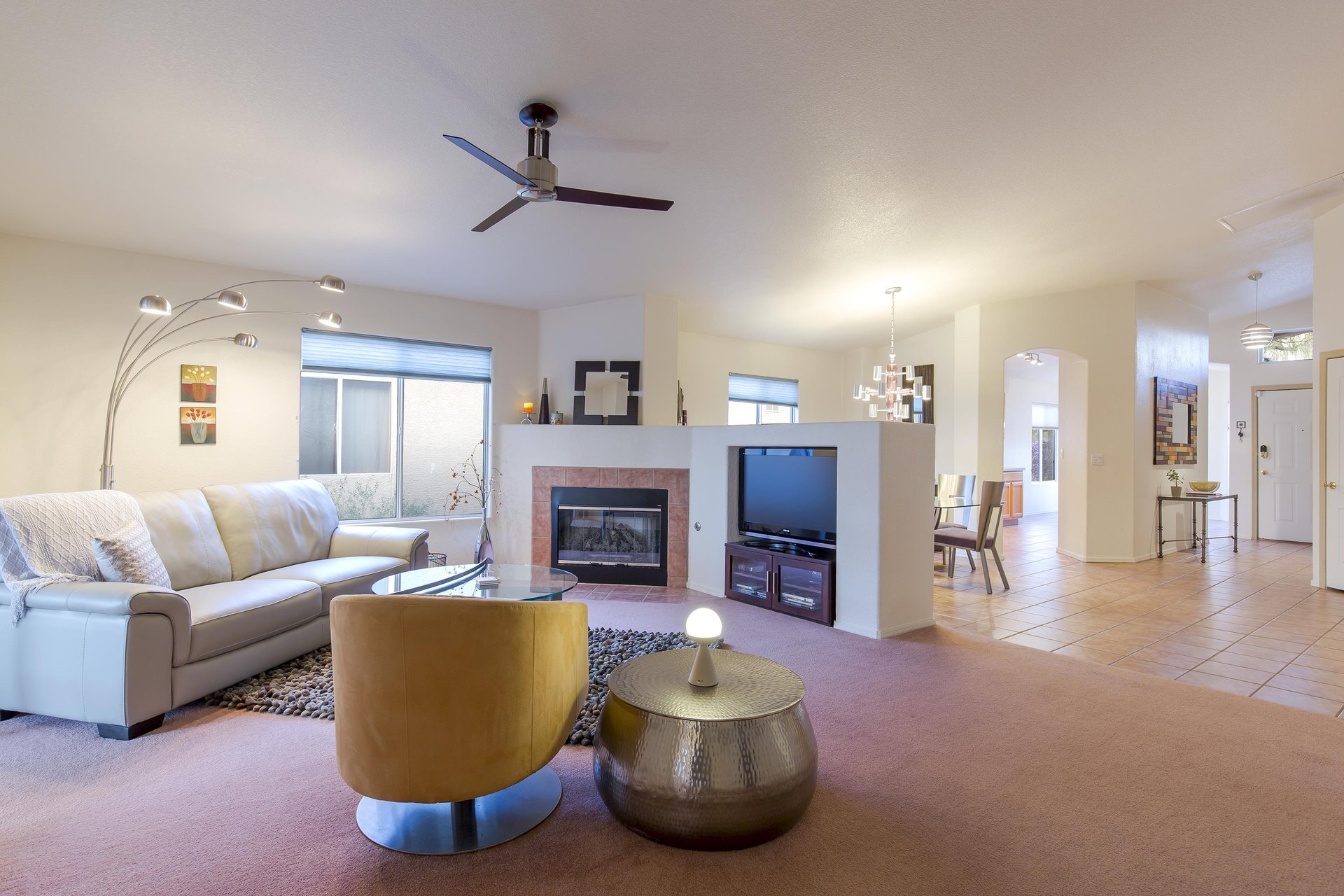 Ample seating, patio access, fireplace, and a flatscreen TV.